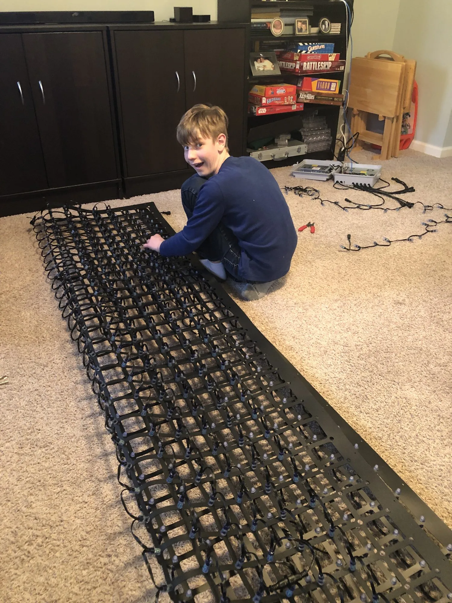 Max wiring a pixel panel on the living room floor, 2020
