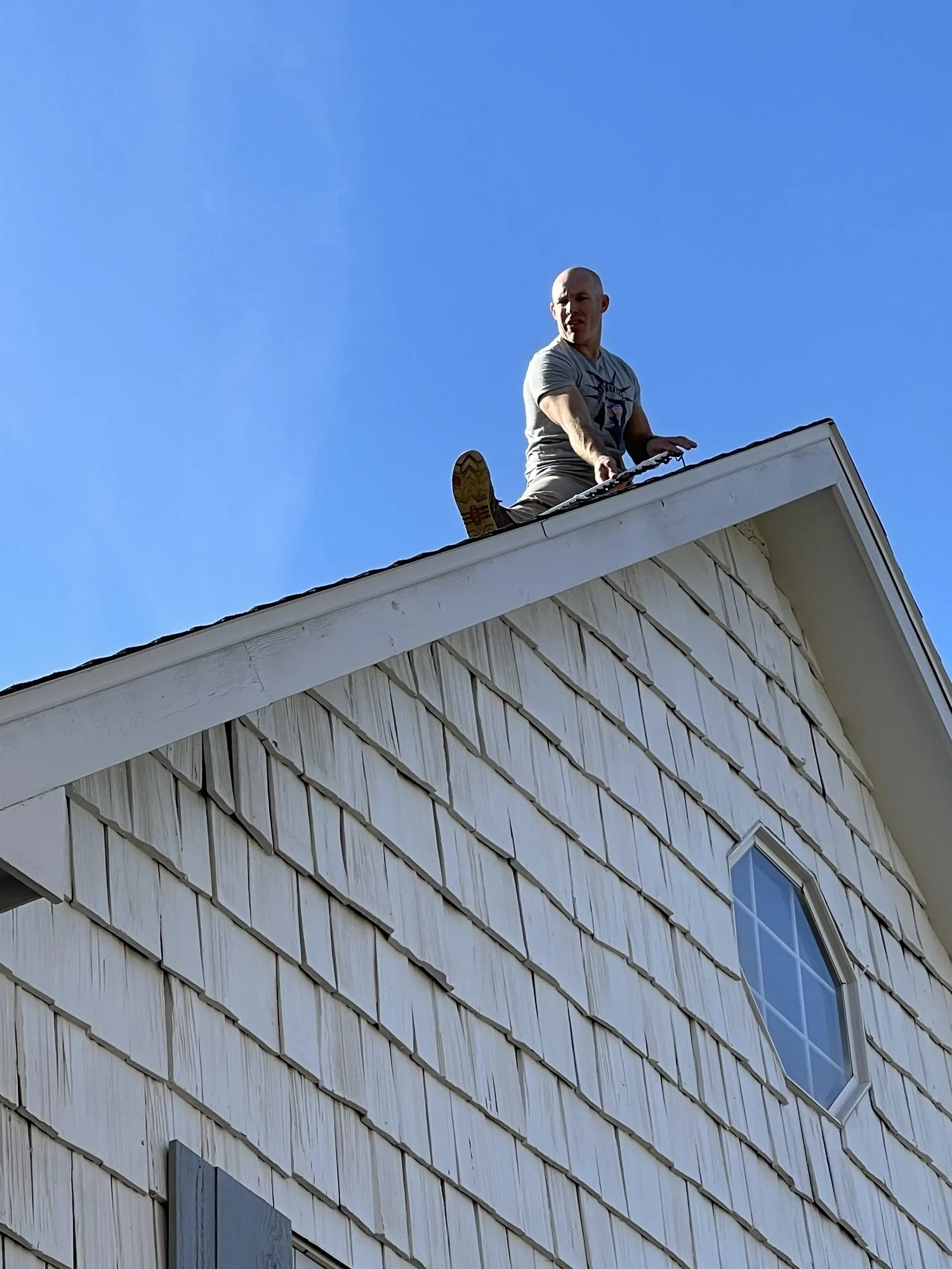 Dan from David Smith Radon Remedies on the roof peak, 2021